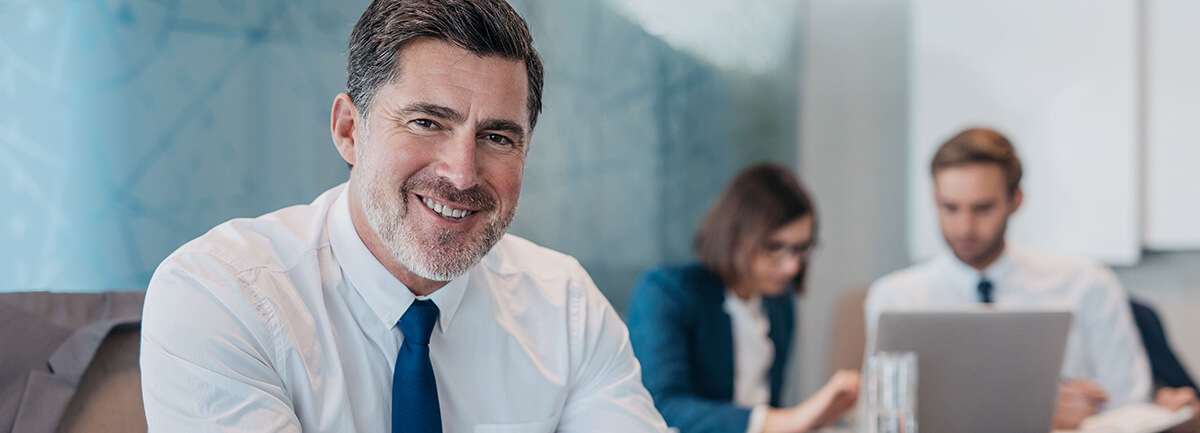 Business an in a white dress shirt smiling